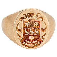 Finely detailed family crest signet ring crafted in 10 karat yellow gold. The signet ring weighs a hefty 11.1 grams. The signet mount features a Valois style arms, with a French style helmet to the top. The base of the signet mount features the family name "Bradley" (also engraved "William L Bradley"). The low rise ring (2mm - 0.15 inches) sits comfortably on the finger. The ring is in very good condition. We have not cleaned it in order to preserve the patina and collector value. Particulars: Weight: 11.1 grams Stones: N/A. Size & Measurements: The ring is a size 9.5 (sizable). The mount measures 16.5mm in length (0.64 inches) and 15mm wide (0.59 inches) rising 2mm from the finger. Metal & Hallmark: 10 karat yellow gold. The ring is hallmarked "10k" and "Heraldry House". Style Français, Vintage Fine Jewelry, Yellow Gold Jewelry, Ring Crafts, Modern Ring, Ring Oval, Art Deco Era, Family Crest, Vintage Art Deco