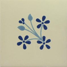 a blue and white tile with small flowers on it's side, in the shape of a flower