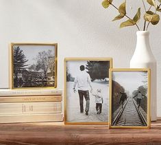 there are three pictures on the shelf next to each other and one is holding a child's hand