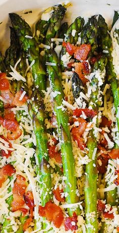 asparagus and tomatoes with parmesan cheese on top