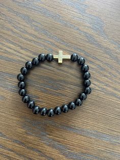 Religious Bracelet, Catholic Bracelet, Cross Bracelet, bead Bracelet, Pretty black beaded bracelet with gold cross. Adjustable Black Cross Bracelet, Spiritual Beaded Cross Bracelets, Adjustable Beaded Cross Bracelet, Black Cross Bracelet As Gift, Adjustable Cross-shaped Beaded Bracelets, Cross Bracelets, Black Beaded Bracelet, Catholic Bracelet, Black Beaded Bracelets