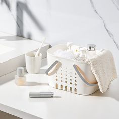 a white bathroom sink with soap, toothbrushes and other items on the counter