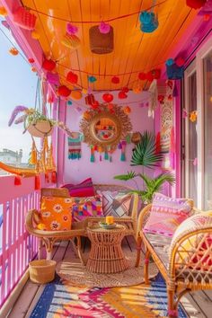 an outdoor covered porch with wicker furniture and colorful decorations on the ceiling, along with potted plants