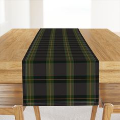 the table is covered with a black and green tartan checkered table runner on it