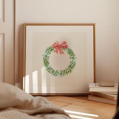 a christmas wreath is hanging on the wall next to a bed