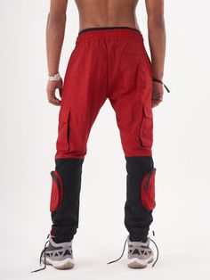 Double-color red and black joggers with four functional cargo pockets on the knees and elastic ankles. FEATURES Slim Fit Made up of 95% Cotton and 5% Elastane Jogger comfort Drawstring waist SIZE GUIDE Model's height and weight: 6"1 feet & 180 lbs. (185 cm & 82 kg ) Model wears size: L Red Sports Joggers With Elastic Waistband, Streetwear Cargo Jeans With Functional Pockets, Sporty Outdoor Joggers With Hip Pockets, Functional Cargo Jeans For Streetwear, Hip Hop Cargo Pants With Side Pockets For Outdoor, Urban Joggers With Hip Pockets For Outdoor, Functional Cargo Jeans For Outdoor Activities, Functional Cargo Jeans With Side Pockets For Outdoor, Functional Cargo Jeans With Side Pockets For Outdoor Activities