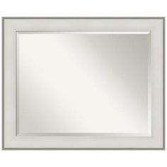 a white framed mirror with silver trim on the edges and an empty space for text