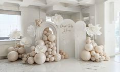 balloons are arranged in the shape of flowers and archs for an entrance to a wedding reception