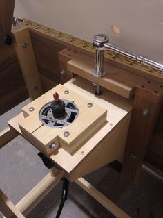 a small machine is being built with wood and metal parts on it's sides