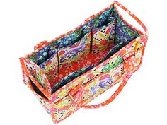 an orange and pink floral print bag with two compartments on the front, one is open