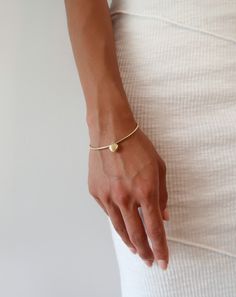 Add some romance to your outfit with this gold puffy heart bangle. This diamond-cut flex bangle is meticulously crafted from sterling silver and glimmers as it catches the light. This heart charm has a brushed finish, imitating luxurious satin. Made in Italy. Details: Metal: 14k 1-Micron Gold-Plated on Sterling Silver Base & Anti-Tarnish Coating Charm: 10mm Puffed Heart Charm Length: 7" Bangle Opening: .5" Flexible Opening Gold Tarnish-resistant Heart Bracelet As Gift, Gold Plated Heart Bangle Bracelet, Elegant Metal Heart Bangle Bracelet, Gold Bangle With Heart Charm, Gold-plated Heart Bangle Bracelet, Puffed Heart, Puffy Heart, Cz Stone, Heart Charm