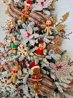 a christmas tree decorated with gingerbreads and other holiday decorations