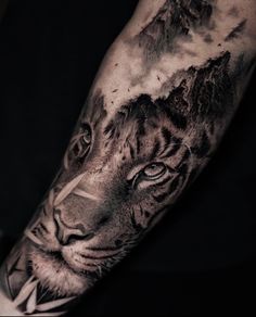 a black and white tiger with mountains in the background tattoo design on forearm or arm