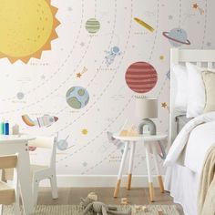 a child's bedroom decorated in space themed wallpaper