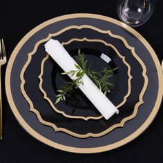 a black and gold place setting with silverware