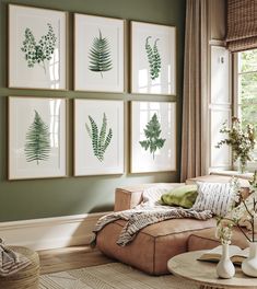 a living room filled with furniture and pictures hanging on the wall above a coffee table