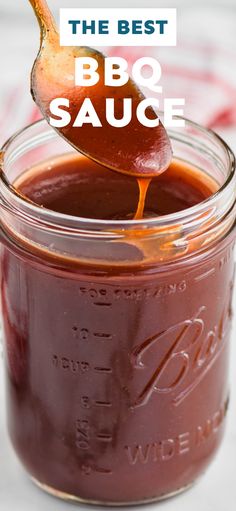 the best bbq sauce in a mason jar with a spoon full of bbq sauce