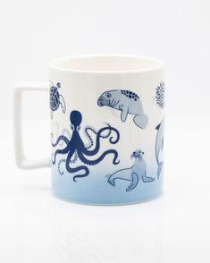 an octopus and sea animals mug on a white background with blue underglouds