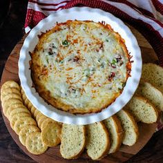 a bowl of cheese dip surrounded by crackers