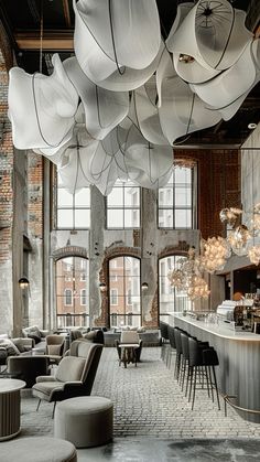 the interior of a restaurant with large chandeliers hanging from the ceiling