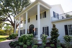 a white house with columns and black shutters