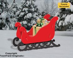 a red sleigh with presents on it in the snow