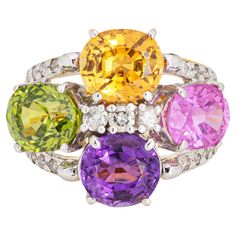 Stylish multi semi-precious gemstone cocktail ring crafted in 14 karat yellow gold. Citrine, amethyst, pink topaz & peridot each measure 8.5mm x 7mm. Diamonds total an estimated 0.40 carats (estimated at L-M color and SI2-I2 clarity). The stones are in very good condition and free of cracks or chips. The multi-colored semi-precious gemstones add a beautiful pop of color on the hand. Sprinkled with diamonds, the ring is great worn during the day, or at night for a glam look. The low rise ring (8m Gemstone Diamond Ring, Rainbow Gemstones, Gold Cocktail Ring, Gold Cocktail, Pink Topaz, Ring Crafts, Modern Ring, Precious Gemstones, Cocktail Ring