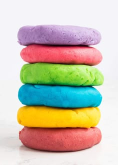 a stack of colorful doughnuts sitting on top of each other