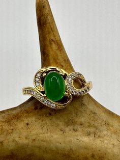 vintage green fun jade ring  Setting is a golden finished bronze setting  This is one of my hand re finished treasures. Salvaged from vintage.  Size  9.5 Re sizing can be done for a $20 fee and may take up to a week.  Engraving is $4 per letter.  Thank you for supporting a veteran's small business. All jewelry is shipped free within the US in a stylish gift box Vintage Green Rings With Stone Setting, Vintage Jade Jewelry For Anniversary, Antique Gold Emerald Cabochon Ring, Antique Handmade Green Emerald Ring, Antique Green Emerald Ring Collectible, Antique Green Emerald Collectible Ring, Vintage Gold Emerald Cabochon Ring, Vintage Oval Jade Emerald Ring, Vintage Gold Emerald Ring For Collectors