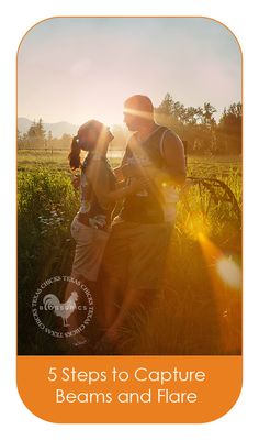 two people are standing in the grass with their arms around each other and one person is holding