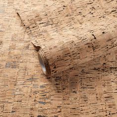 a roll of cork paper sitting on top of a wooden table