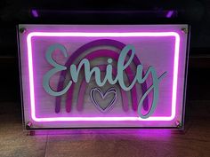 a neon sign that says,'enjoy'with a heart on the bottom and an embellishment in the middle