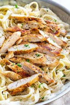 chicken and pasta in a pan with parsley on top