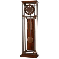 an old clock is in a metal frame with wood accents on the front and sides