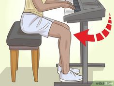 a person sitting at a desk playing the piano with an arrow pointing up to it