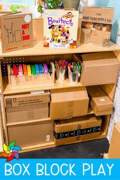 cardboard boxes are stacked on top of each other in front of a bookshelf