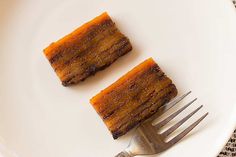 two pieces of cake sitting on top of a white plate next to a silver fork