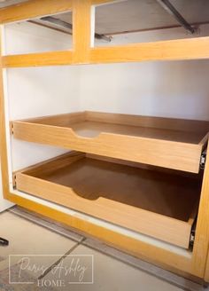 two wooden shelves in the corner of a room