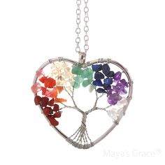 Embrace positive energy with the Maya's Grace Chakra Necklace. This vibrant pendant adds a pop of color to any outfit and features an 18-inch silver cable chain with a 2-inch extension and lobster clasp. Each crystal in the pendant represents a unique quality: Purple: Symbolizes romance and nobility. Tiger's Eye: Enhances inspiration and career success. White: Associated with wisdom and clarity. Pink: Represents love and popularity. Yellow: Symbolizes wealth and good fortune. Tawny: Stands for stability. Green: Represents justice and growth. Jewelry Care: Store in a clean, dry place. Do not wear in water or during sports activities. Clean gently with a soft cloth. About Maya's Grace: At Maya's Grace, a minority-owned brand, our mission is to make beautiful, high-quality jewelry accessible Rainbow Heart Pendant Jewelry Gift, Rainbow Heart Pendant Necklace For Gift, Rainbow Heart Necklaces As Gifts, Heart-shaped Rainbow Necklace For Gift, Gift Rainbow Heart Pendant Necklace, Silver Heart-shaped Gemstone Beads Jewelry, Silver Heart Jewelry With Gemstone Beads, Silver Heart-shaped Jewelry With Gemstone Beads, Holistic Multicolor Gemstone Necklace