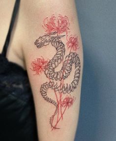 a woman's arm with a dragon tattoo on the left side of her body