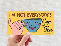 someone holding up a card that says i'm not everybody's cup of tea