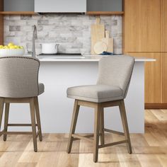 two chairs sitting in front of a counter top with fruit on the table next to it