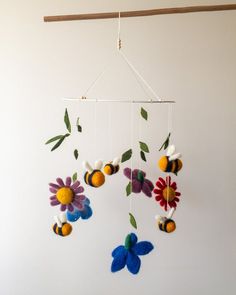 a mobile with flowers hanging from it's side