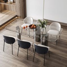 a glass table with chairs around it and fruit on the plate in front of it