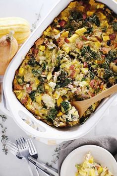 a casserole dish with spinach, cheese and other toppings on the side