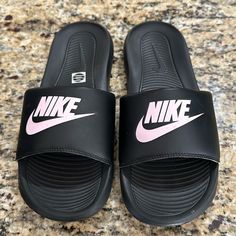 Woman Black And Pink Summer Nike Sandals Size 9 Gently Used Once- Wore From Store To Pool Party And Never Worn Again Nike Synthetic Flip Flops For Spring, Trendy Black Sport Sandals For Beach, Nike Flat Flip Flops For Summer, Trendy Open Toe Sports Sandals, Nike Summer Flip Flops With Round Toe, Black Flat Sport Sandals For Beach, Pink Casual Slides With Round Toe, Trendy Black Flip Flops With Cushioned Footbed, Black Summer Sandals With Cushioned Footbed