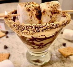 an ice cream sundae with marshmallows, chocolate sauce and graham crackers