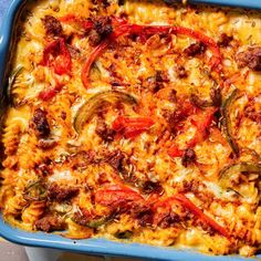 a blue casserole dish filled with meat and vegetables