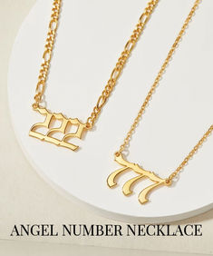 three gold necklaces with the word angel number necklace written in hebrew letters on them