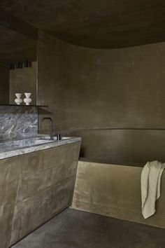 a bath room with a large tub and a sink